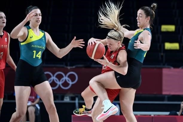 Belgium's Julie Vanloo handles the ball as Australia's Marianna Tolo and Jenna O'hea react in the women's preliminary round group C basketball match...