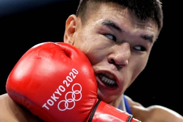 Kazakhstan's Ablaikhan Zhussupov takes a punch from USA's Delante Marquis Johnson during their men's welter preliminaries round of 16 boxing match...