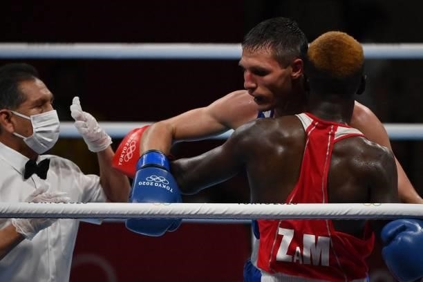 Zambia's Steven Zimba and Russia's Andrei Zamkovoi fight during their men's welter preliminaries round of 16 boxing match during the Tokyo 2020...