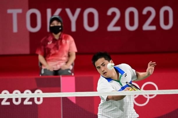 S Phillip Chew hits a shot in his men's doubles badminton group stage match with USA's Ryan Chew against Germany's Mark Lamsfuss and Germany's Marvin...