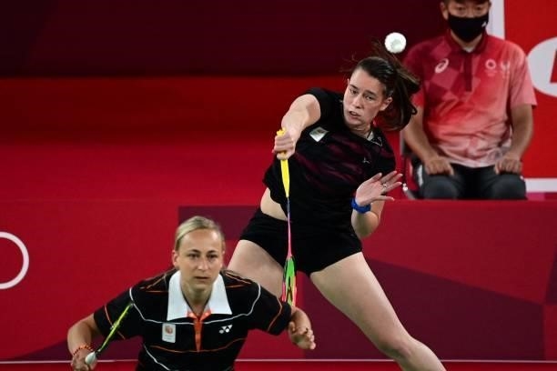 Netherlands' Cheryl Seinen hits a shot next to Netherlands' Selena Piek in their women's doubles badminton group stage match against Japan's Wakana...