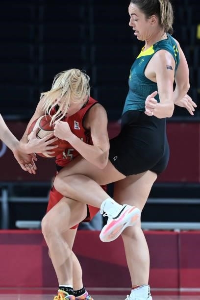 Belgium's Julie Vanloo handles the ball as Australia's Jenna O'hea reacts in the women's preliminary round group C basketball match between Australia...