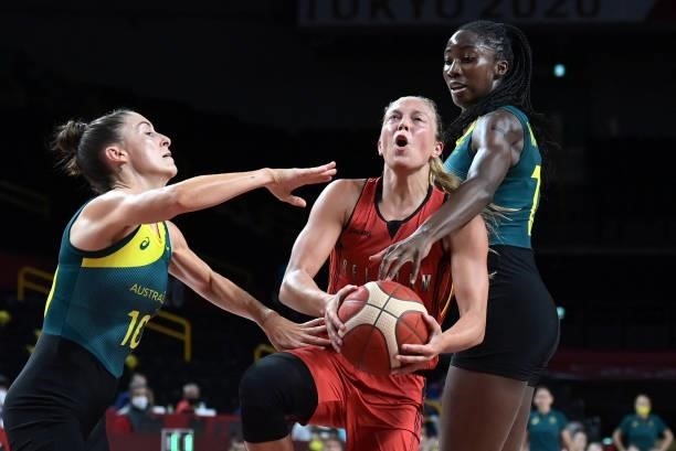 Belgium's Julie Allemand handles the ball past Australia's Ezi Magbegor and Katie Ebzery in the women's preliminary round group C basketball match...