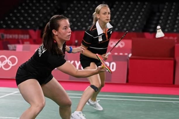 Netherlands' Cheryl Seinen hits a shot next to Netherlands' Selena Piek in their women's doubles badminton group stage match against Japan's Wakana...