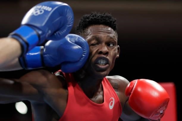 Uganda's Shadiri Bwogi takes a punch from Georgia's Eskerkhan Madiev during their men's welter preliminaries round of 16 boxing match during the...
