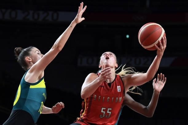 Belgium's Julie Allemand shoots the ball as Australia's Katie Ebzery watches in the women's preliminary round group C basketball match between...