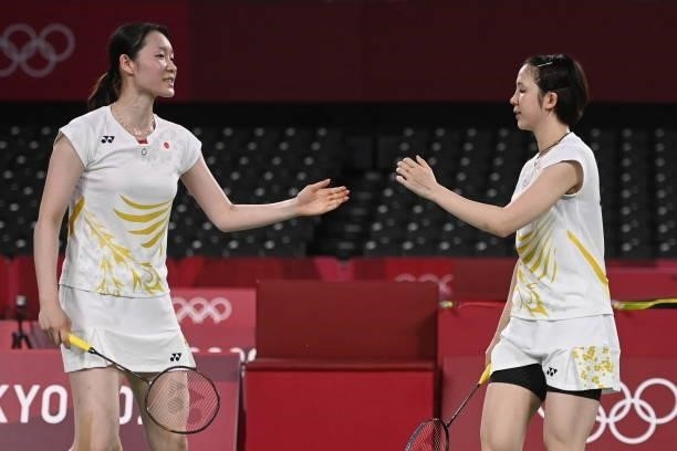 Japan's Mayu Matsumoto and Japan's Wakana Nagahara celebrate victory in their women's doubles badminton group stage match against Netherlands' Cheryl...
