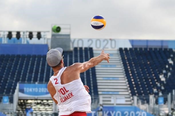 Poland's Grzegorz Fijalek serves the ball during their men's preliminary beach volleyball pool E match between Poland and Chile during the Tokyo 2020...