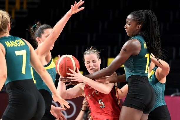Belgium's Kim Mestdagh fights for the ball with Australian players in the women's preliminary round group C basketball match between Australia and...