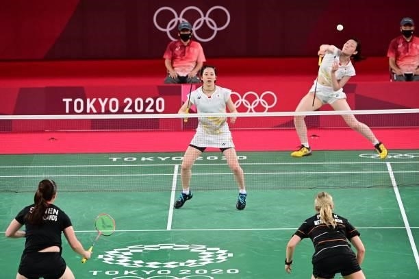 Japan's Wakana Nagahara looks on as Japan's Mayu Matsumoto hits a shot in their women's doubles badminton group stage match against Netherlands'...