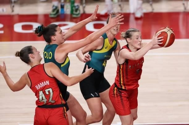 Belgium's Kim Mestdagh catches the ball past Australia's Marianna Tolo in the women's preliminary round group C basketball match between Australia...