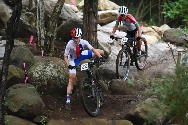 Czech Republic's Jitka Cabelicka gets off her bike to walk a rocky section as Portugal's Raquel Queiros follows in the cycling mountain bike women's...