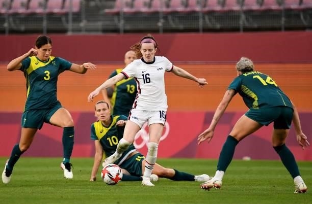 S midfielder Rose Lavelle dribbles the ball among Australia's forward Kyra Cooney-Cross and Australia's defender Alanna Kennedy during the Tokyo 2020...