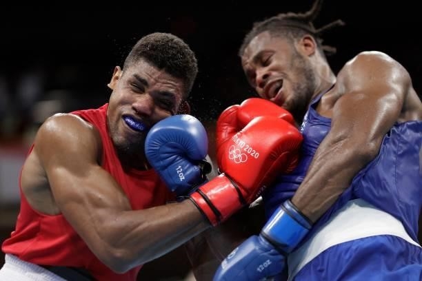 Brazil's Abner Teixeira and Britain's Cheavon Clarke fight during their men's heavy preliminaries round of 16 boxing match during the Tokyo 2020...