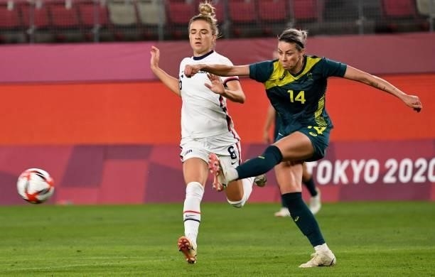 Australia's defender Alanna Kennedy clears the ball from USA's midfielder Kristie Mewis during the Tokyo 2020 Olympic Games women's group G first...