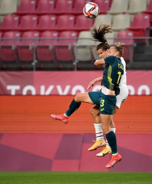 Australia's midfielder Tameka Yallop USA's forward Tobin Heath fight in the air during the Tokyo 2020 Olympic Games women's group G first round...