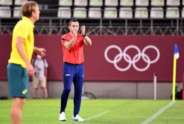 S head coach Vlatko Andonovski instructs his players beside Australia's coach Tony Gustafsson during the Tokyo 2020 Olympic Games women's group G...