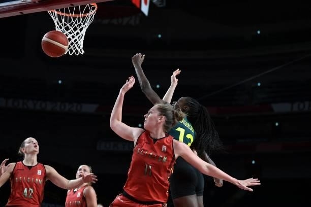 Australia's Ezi Magbegor and Belgium's Emma Meesseman fight for the rebound in the women's preliminary round group C basketball match between...