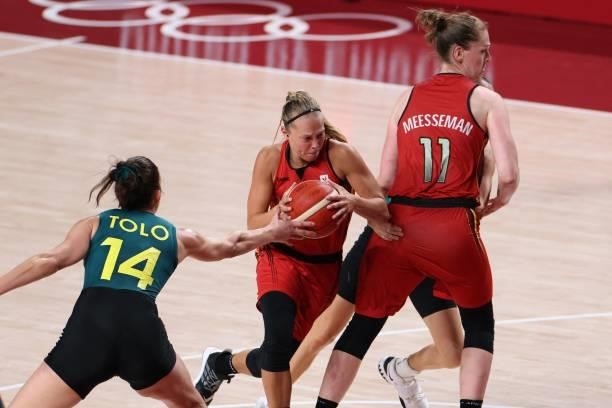 Belgium's Julie Vanloo goes to the basket past Australia's Marianna Tolo in the women's preliminary round group C basketball match between Australia...