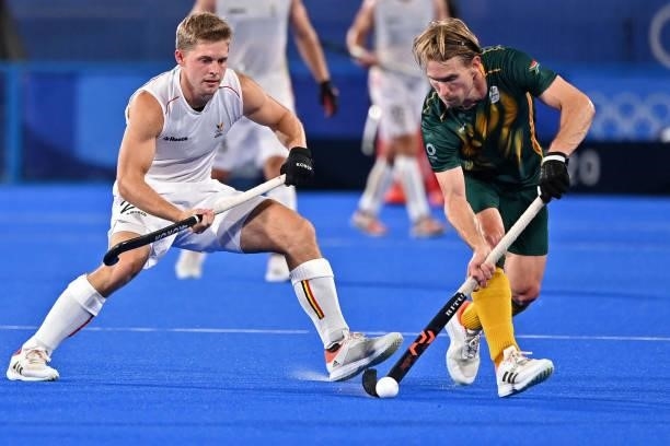 South Africa's Taine Paton carries the ball as Belgium's Victor Nicky Wegnez looks on during their men's pool B match of the Tokyo 2020 Olympic Games...