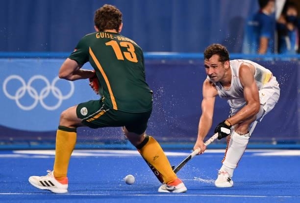 Belgium's Sebastien Dockier is challenged by South Africa's Matthew Guise-Brown during their men's pool B match of the Tokyo 2020 Olympic Games field...