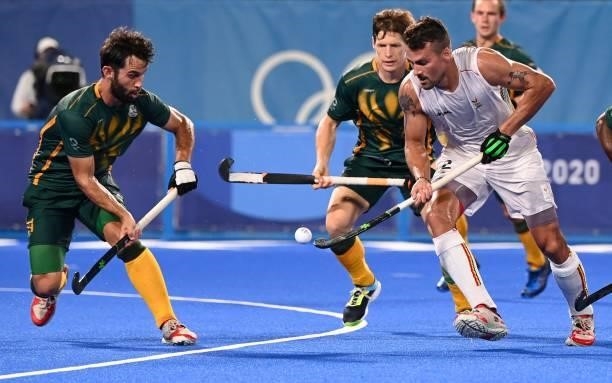 Belgium's Simon Pierre Gougnard is marked by South Africa's Jethro Ray Eustice during their men's pool B match of the Tokyo 2020 Olympic Games field...