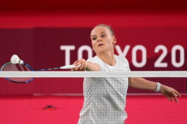 Estonia's Kristin Kuuba hits a shot to Thailand's Busanan Ongbamrungphan in their women's singles badminton group stage match during the Tokyo 2020...