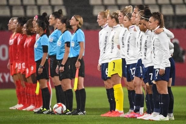 Britain's and Canada's team poses before the Tokyo 2020 Olympic Games women's group E first round football match between Canada and Britain at the...