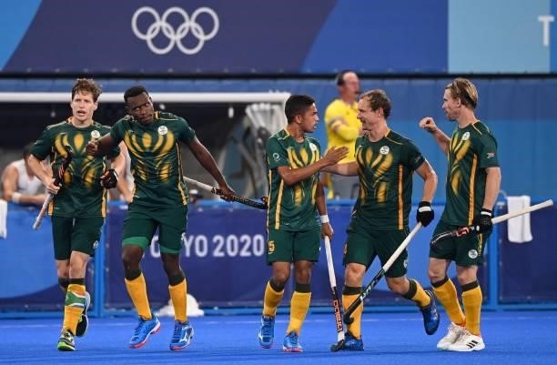 South Africa's Abdud Dayaan Cassiem celebrates with teammates after scoring against Belgium during their men's pool B match of the Tokyo 2020 Olympic...