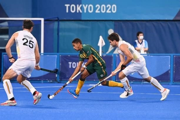 South Africa's Abdud Dayaan Cassiem drives the ball during the men's pool B match of the Tokyo 2020 Olympic Games field hockey competition against...