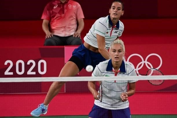 Bulgaria's Gabriela Stoeva looks on as Bulgaria's Stefani Stoeva hits a shot in their women's doubles badminton group stage match against Thailand's...