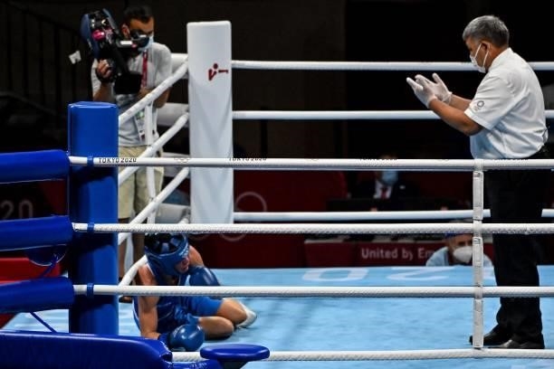 Finland's Mira Marjut Johanna Potkonen falls as she fights France's Maiva Hamadouche during their women's light preliminaries boxing match during the...