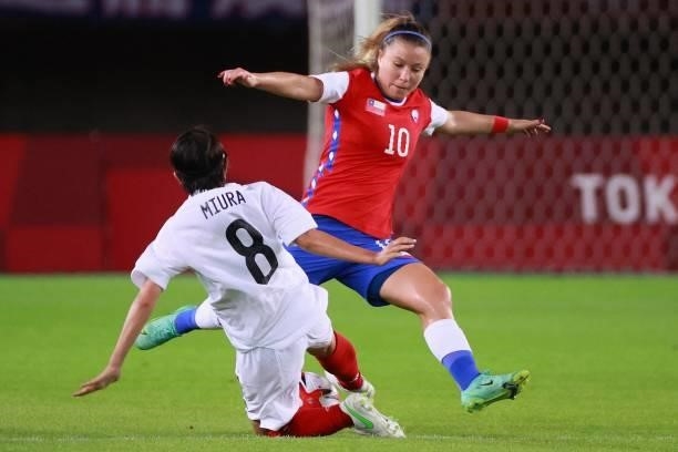 Chile's midfielder Yanara Aedo is tackled by Japan's midfielder Narumi Miura during the Tokyo 2020 Olympic Games women's group E first round football...