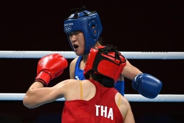 Thailand's Baison Manikon China's Gu Hong fight during their women's welter preliminaries round of 16 boxing match during the Tokyo 2020 Olympic...