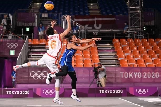 China's Yang Shuyu fights for the ball with Italy's Raelin D Alie during the women's quarter final 3x3 basketball match between China and Italy at...