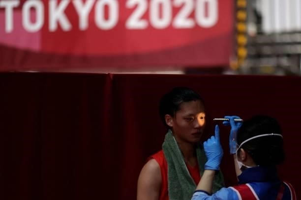 Chinese Taipei's Shih-Yi Wu undergoes a medical check up during her women's light preliminaries boxing match against Sweden's Agnes Alexiusson during...
