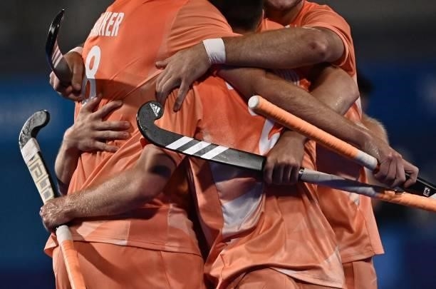 Netherlands' players celebrate after scoring against Canada during their men's pool B match of the Tokyo 2020 Olympic Games field hockey competition,...