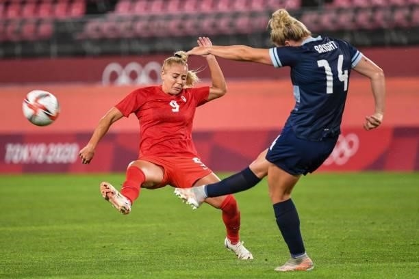 Britain's defender Millie Bright shoots the ball past Canada's forward Adriana Leon during the Tokyo 2020 Olympic Games women's group E first round...