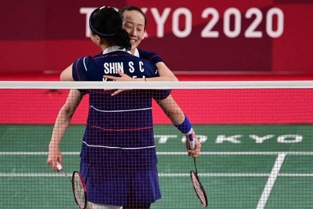 South Korea's Lee So-hee hugs South Korea's Shin Seung-chan after winning their women's doubles badminton group stage match against China's Li Yinhui...