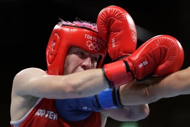 France's Maiva Hamadouche takes a punch from Finland's Mira Marjut Johanna Potkonen during their women's light preliminaries boxing match during the...