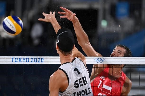 Germany's Julius Thole vies for the ball with Poland's Piotr Kantor during their men's preliminary beach volleyball pool F match between Germany and...