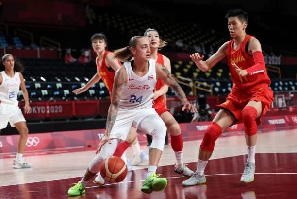Puerto Rico's Jazmon Gwathmey dribbles the ball past China's Huang Sijing in the women's preliminary round group C basketball match between China and...