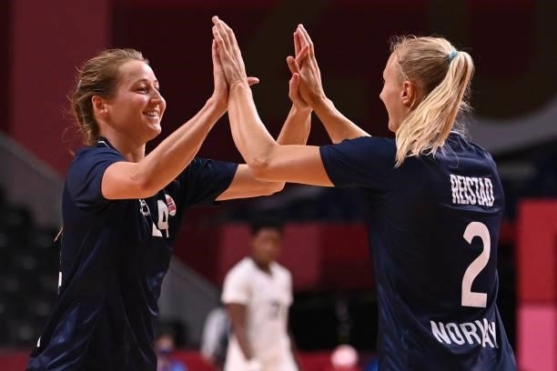 Norway's left wing Sanna Solberg Isaksen celebrates after scoring with a teammate during the women's preliminary round group A handball match between...