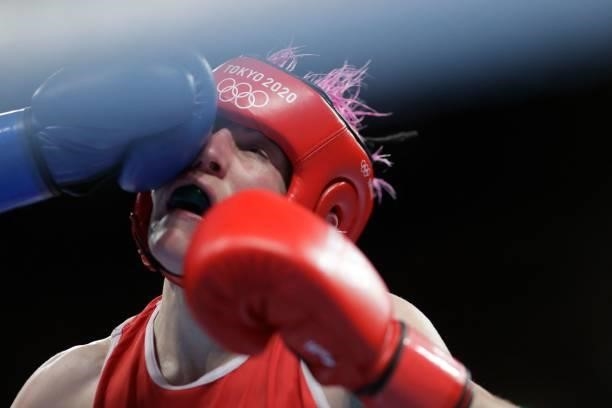 France's Maiva Hamadouche takes a punch from Finland's Mira Marjut Johanna Potkonen during their women's light preliminaries boxing match during the...