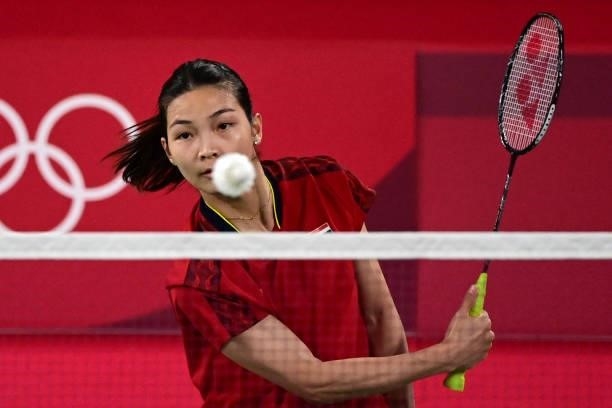 Thailand's Jongkolphan Kititharakul hits a shot in her women's doubles badminton group stage match with Thailand's Rawinda Prajongjai against...