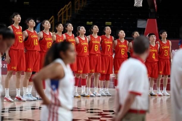 China's players stand in respect durin the national anthem in the women's preliminary round group C basketball match between China and Puerto Rico...