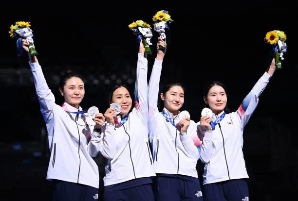 Silver medallist South Korea's fencers celebrate during the medal ceremony for the womens team epee during the Tokyo 2020 Olympic Games at the...