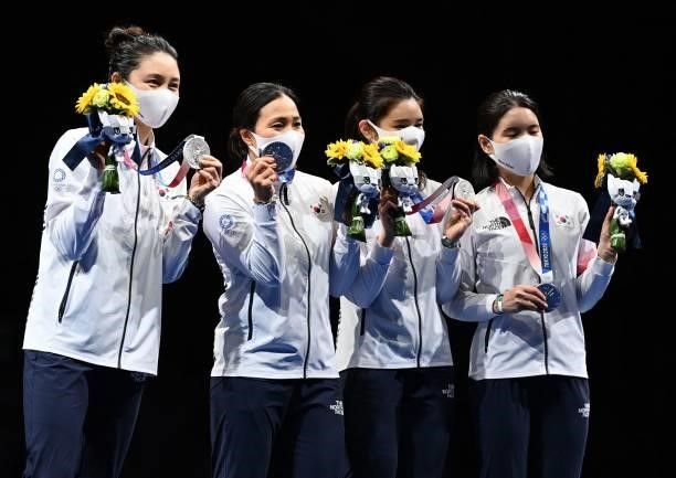 Silver medallist South Korea's fencers celebrate during the medal ceremony for the womens team epee during the Tokyo 2020 Olympic Games at the...