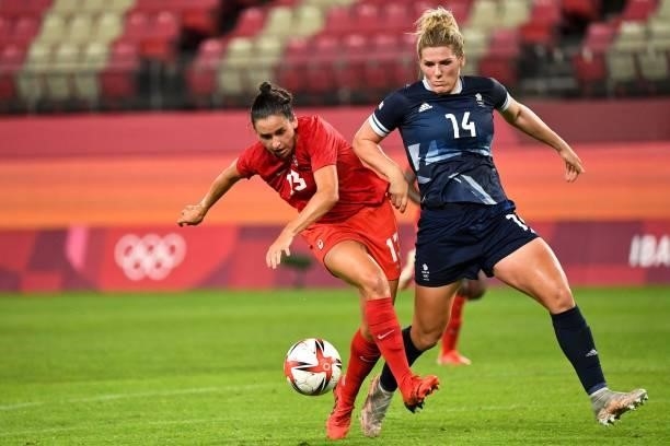 Canada's forward Evelyne Viens fights for the ball with Britain's defender Millie Bright during the Tokyo 2020 Olympic Games women's group E first...