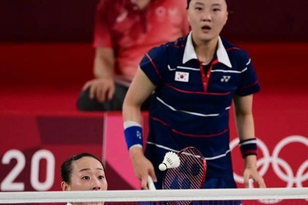 South Korea's Lee So-he hits a shot next to South Korea's Shin Seung-chan in their women's doubles badminton group stage match against China's Li...